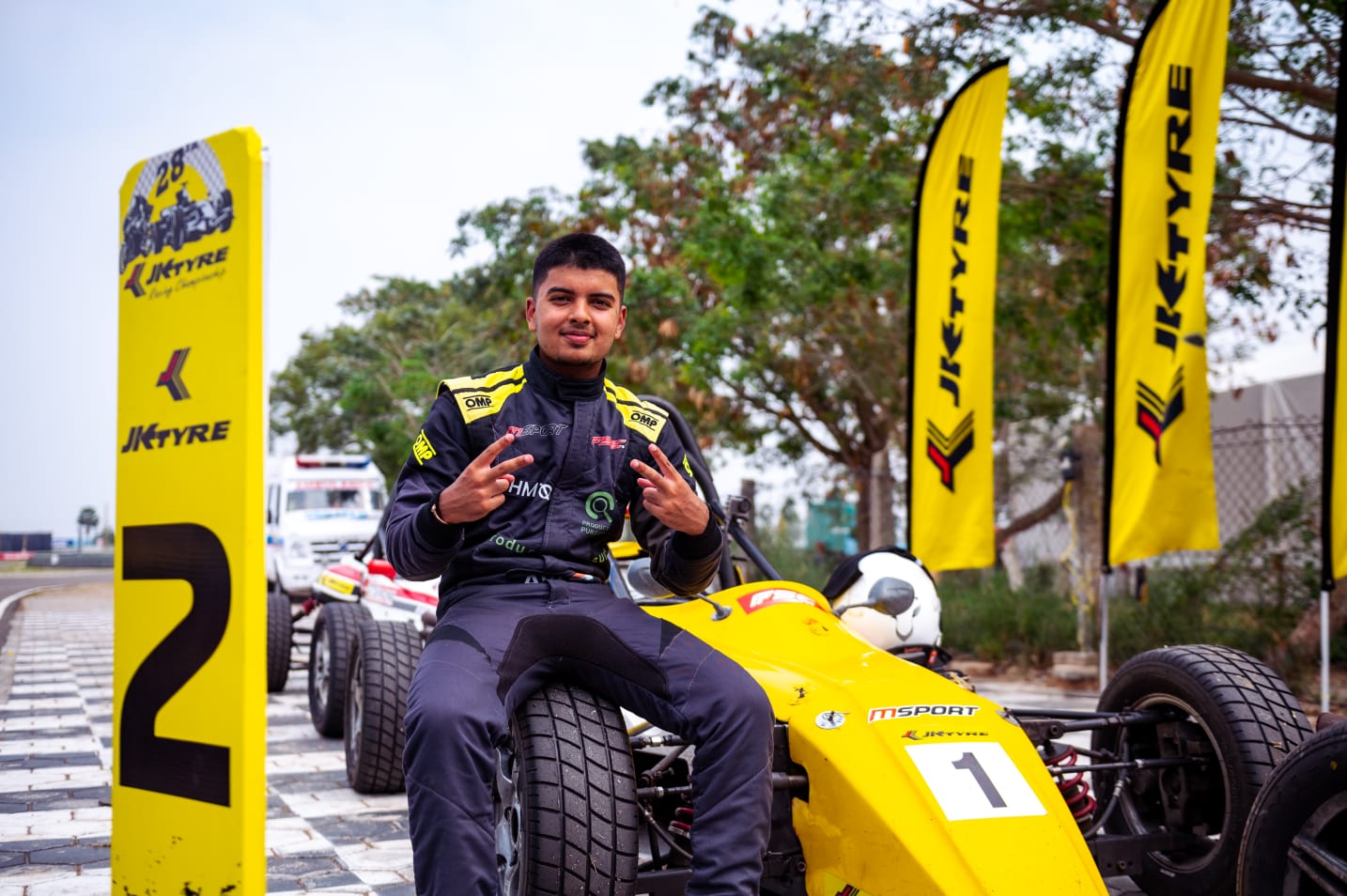 Avi celebrating while seated on his number one formula car